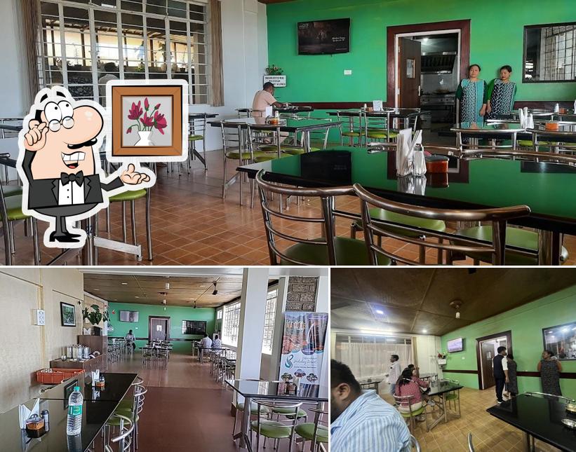 Take a seat at one of the tables at Orange Roots, Pure Veg Restaurant