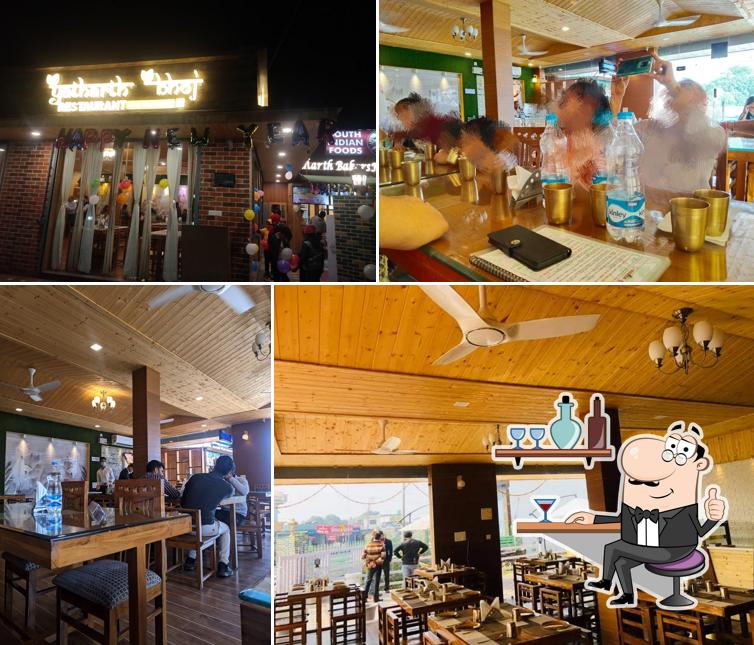 Take a seat at one of the tables at Yatharth Bhoj Pure Veg Smart Restaurant