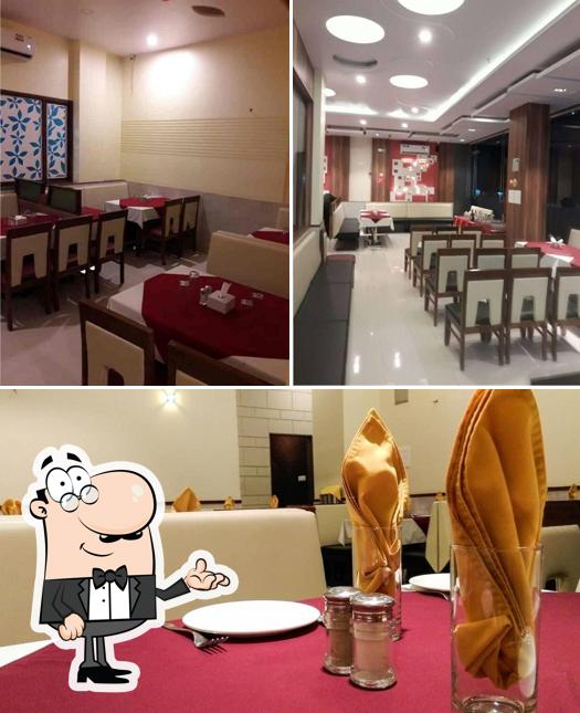 Take a seat at one of the tables at Apoorva Fine Dine