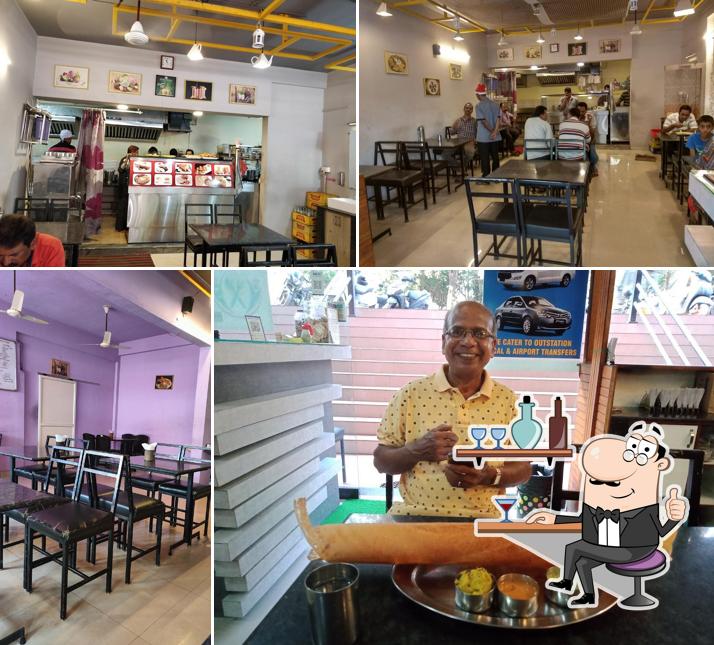 Take a seat at one of the tables at HOTTE THUMBA PURE VEG RESTAURANT