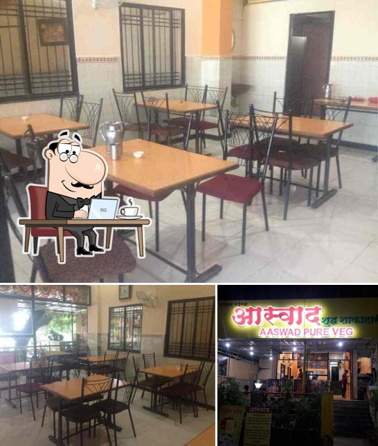 Take a seat at one of the tables at Aaswad Pure Veg