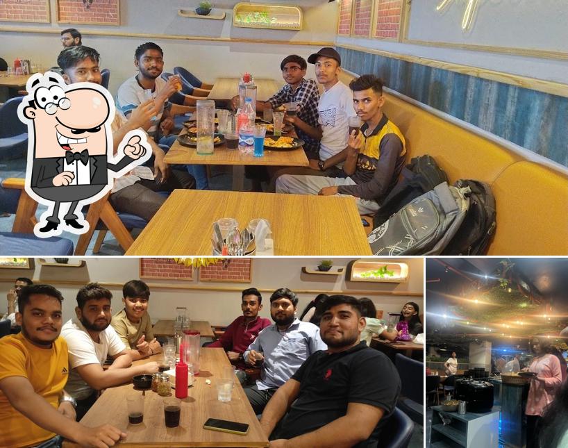 Take a seat at one of the tables at WILLIAM JOHN'S PIZZA SUPERLATIVE BHARUCH