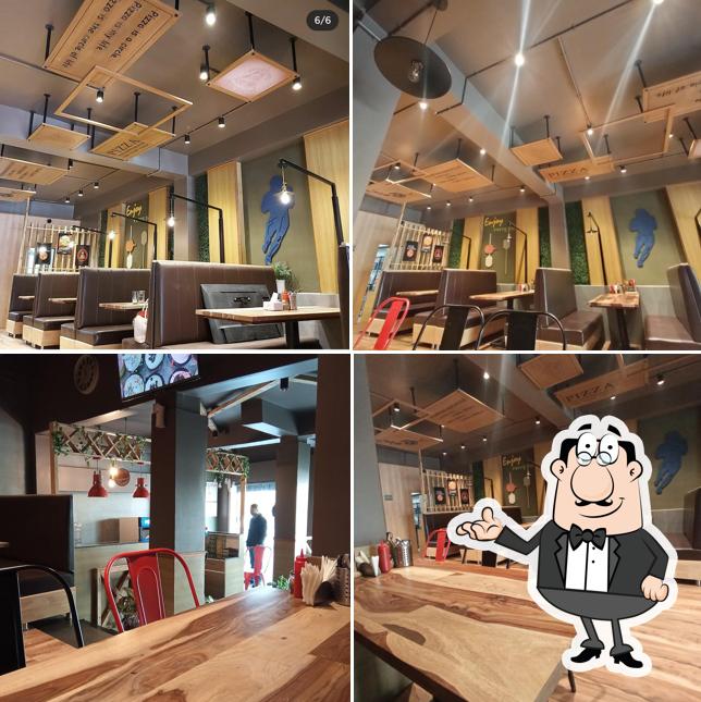 Take a seat at one of the tables at uspizza imphal