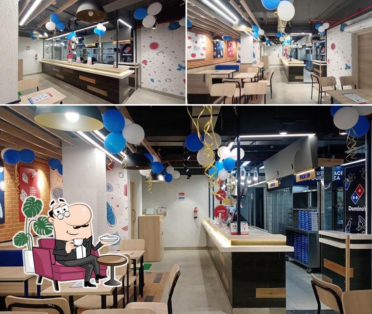 Take a seat at one of the tables at Domino's Pizza Murgasole, Asansol