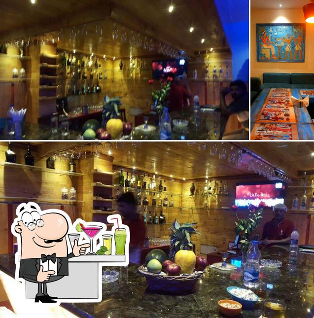 Check out the picture displaying bar counter and interior at Angan Restaurant