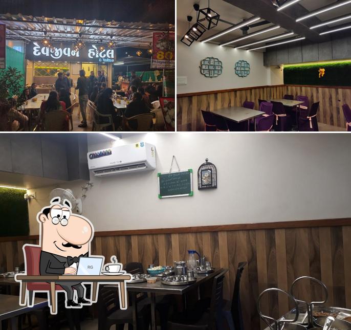 Take a seat at one of the tables at Dev jivan restaurant