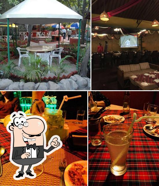 Take a seat at one of the tables at GREEN FIELD FAMILY RESTO BAR