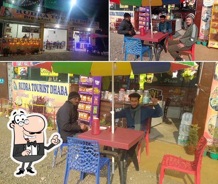 Take a seat at one of the tables at RUDRA TOURIST DHABA