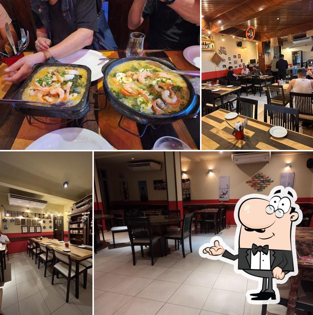 Sente em uma das mesas no Remanso do Peixe