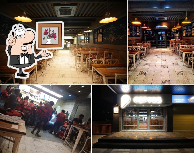 Take a seat at one of the tables at POPTOS MOTABAZAR