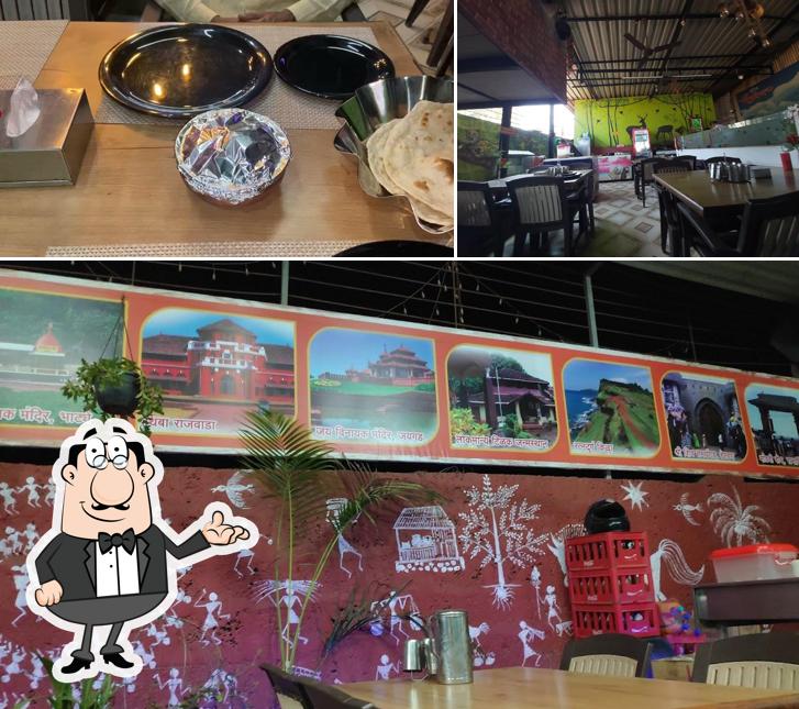 Take a seat at one of the tables at Hotel Shivtej Veg & Non Veg Restaurant