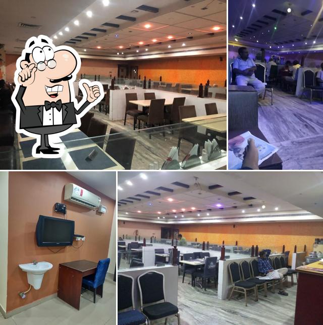 Take a seat at one of the tables at SRI SAI BRUNDAVAN Multicusine & Family Restaurant