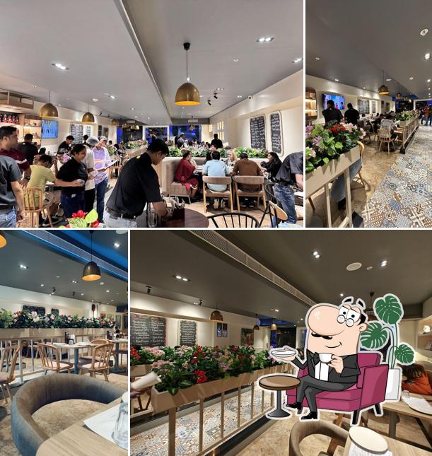 Take a seat at one of the tables at Si Nonna's - The Original Sourdough Pizza IBC Piplod Surat