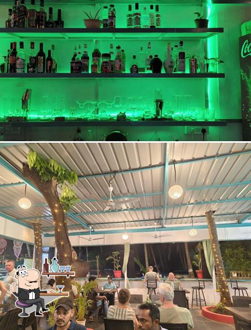 Take a seat at one of the tables at THE OLIVE'S MULTI CUISINE AC RESTAURANT & FOOD DELIVERY AVAILABLE