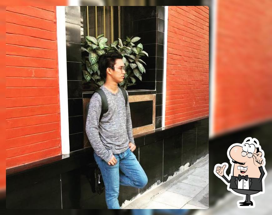 Take a seat at one of the tables at Delhi Dabar Mughlai Restaurant & Bar