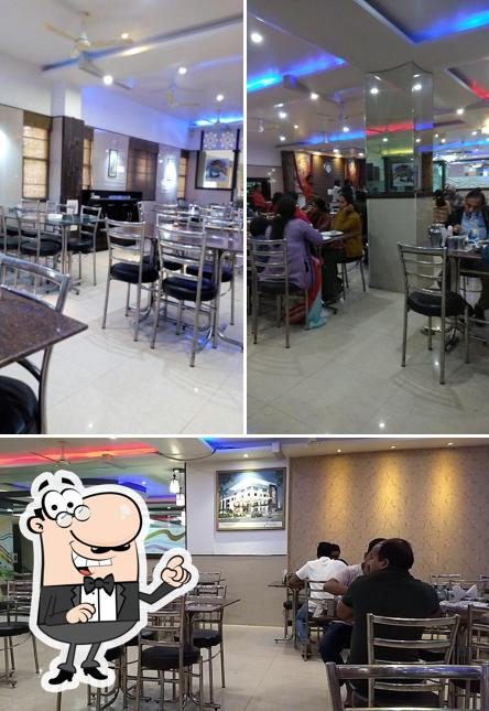 Take a seat at one of the tables at Rasoi Restaurant