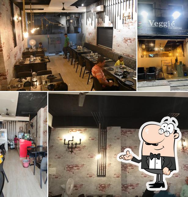 Take a seat at one of the tables at Veggie the restro and cafe