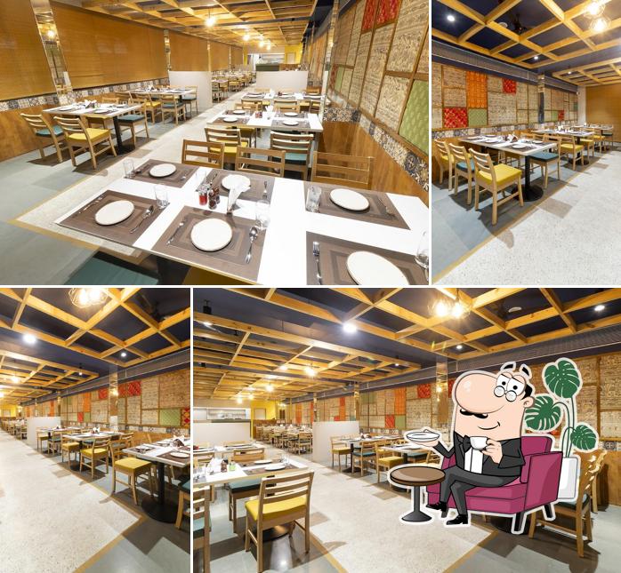 Take a seat at one of the tables at Aahaar Multi Cuisine Restaurant