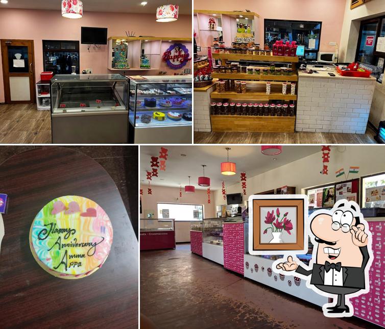 Take a seat at one of the tables at Puppy's Bakery Desserts Birthday Cakes Pizza Burger Shakes Sivakasi