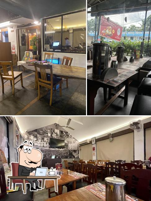 Take a seat at one of the tables at Dindigul Thalappakatti Restaurant