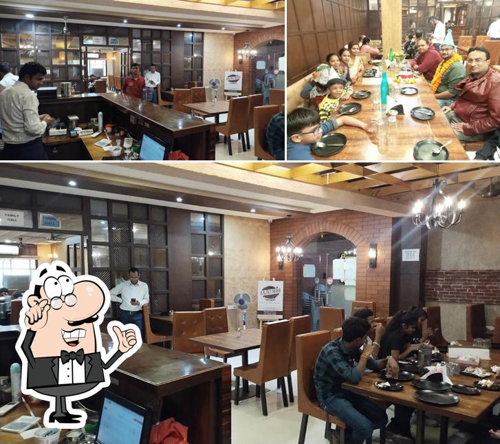 Take a seat at one of the tables at Original Rajkumar Delite( Durga Plaza)