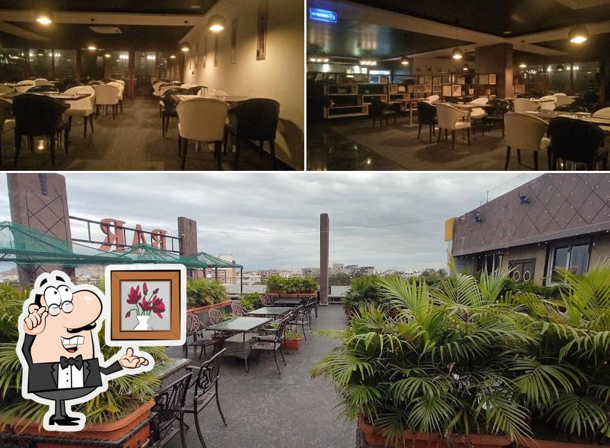 Take a seat at one of the tables at Hotel RNR The Luxury Suits Lodging & Restaurant