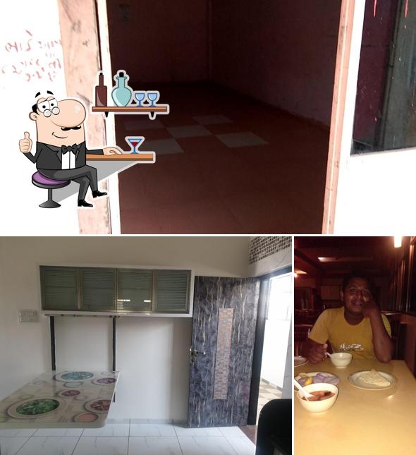 Take a seat at one of the tables at SWAGAT HOTEL & RESTAURANT