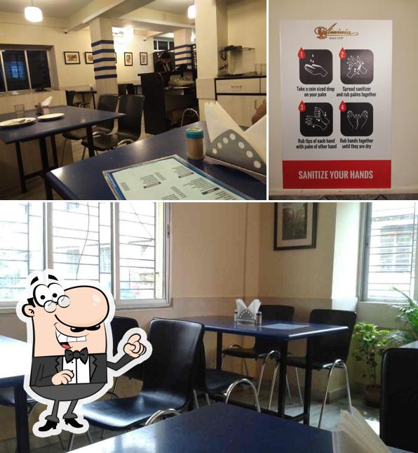 Take a seat at one of the tables at Aminia Restaurant - Garia