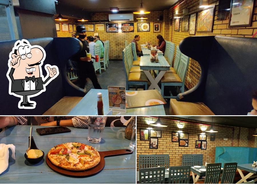 Take a seat at one of the tables at Tossin Pizza Galleria Market