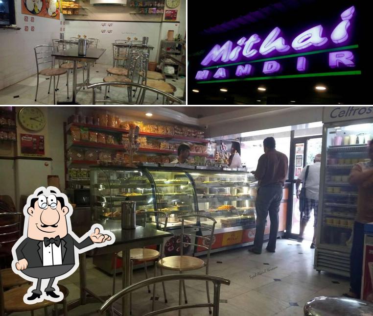 Take a seat at one of the tables at Mithai Mandir