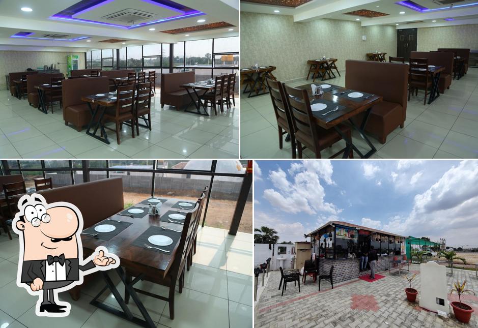 Take a seat at one of the tables at UDUPI SIRI Multi Cuisine Restaurant & Function Hall