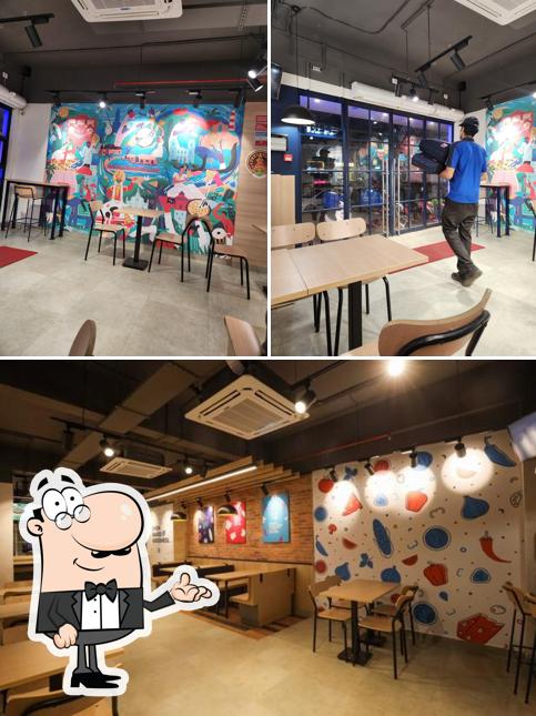 Take a seat at one of the tables at Domino's Pizza Karaparamba, Kozhikode