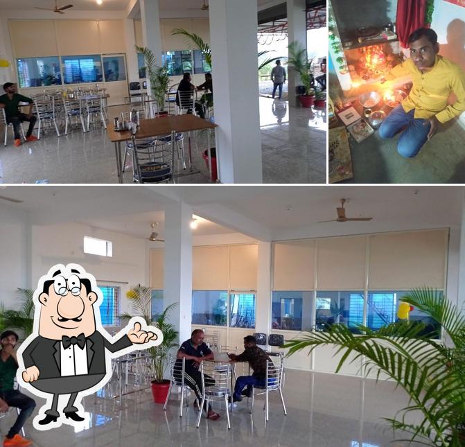 Take a seat at one of the tables at NAIVAIDHYAM HOTEL FAMILY RESTORENT AND DHAWA