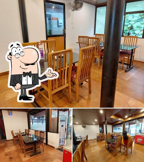 Take a seat at one of the tables at Peter's Kitchen A/C Family Restaurant & Snack Bar