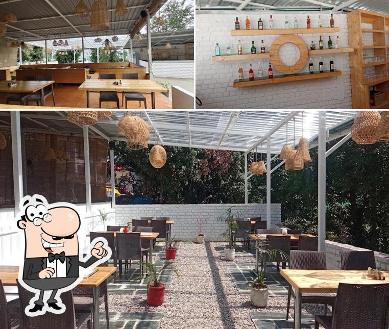 Take a seat at one of the tables at Lamrin’s Cafe & Bar Dharamkot (Best restaurant in Dharamkot)