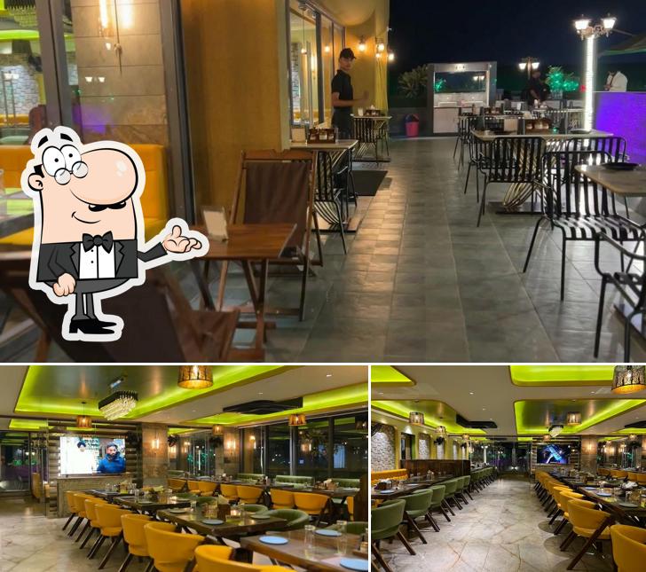 Take a seat at one of the tables at PUNJABI CHAAP CORNER MULTI CUISINE RESTAURANT 100% VEG [ROOFTOP] - BEST RESTAURANT IN MEHSANA