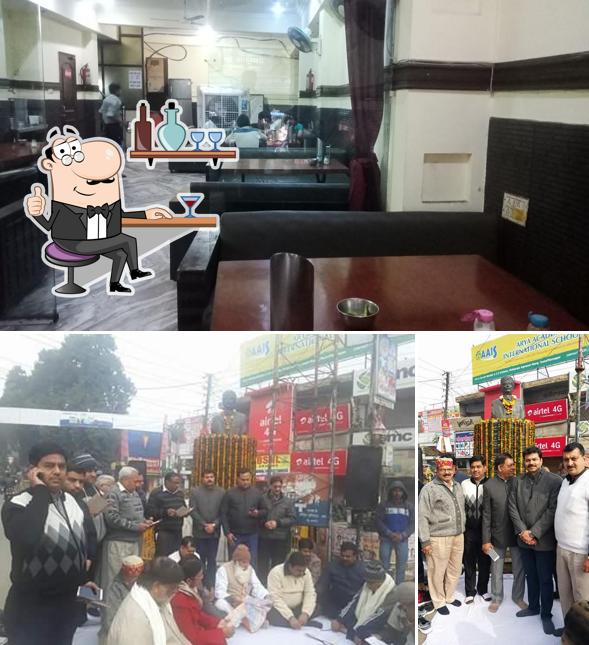 Take a seat at one of the tables at माँ शाकुम्भरी वैष्णो ढाबा