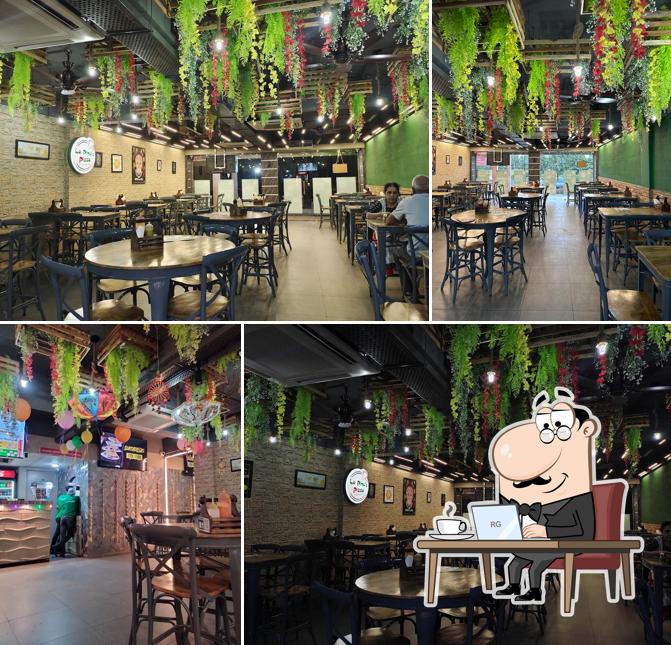 Take a seat at one of the tables at La Pino'z Pizza-Gitanjali Society, Modasa, Gujarat