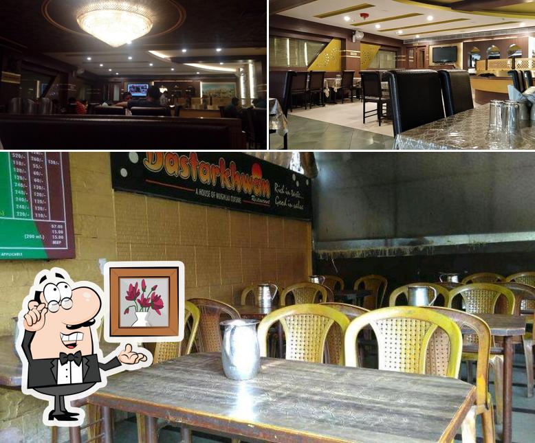 Take a seat at one of the tables at Aadab-e-Dastarkhwan Restaurant