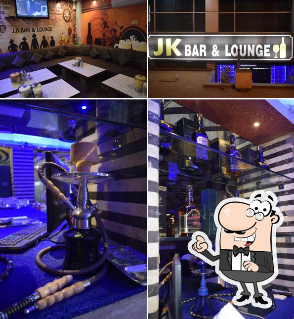 Take a seat at one of the tables at J K bar & Restaurant - Best Bar in Agra/Hookah Lounge in Agra/Lounge & Bar in Agra