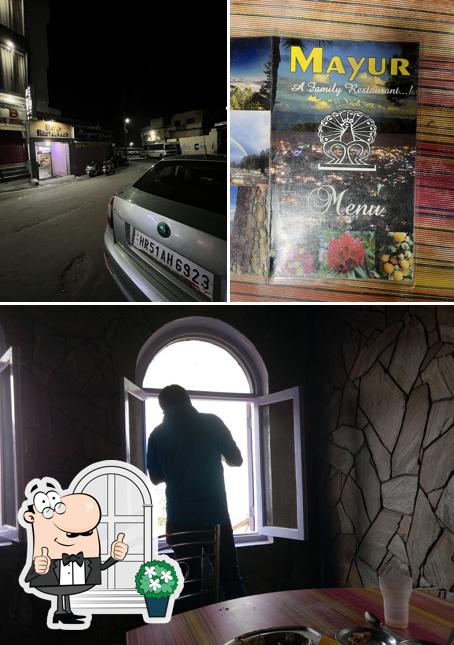 Among different things one can find exterior and dining table at Mayur Restaurant