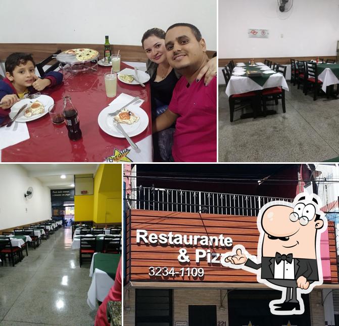 Sente em uma das mesas no Pizzaria Vergilio Restaurante