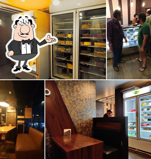 Take a seat at one of the tables at cafe kulfi (TALIPARAMBA)