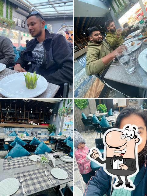 Take a seat at one of the tables at 18_DOWNTOWN & CAFE RESTAURANT