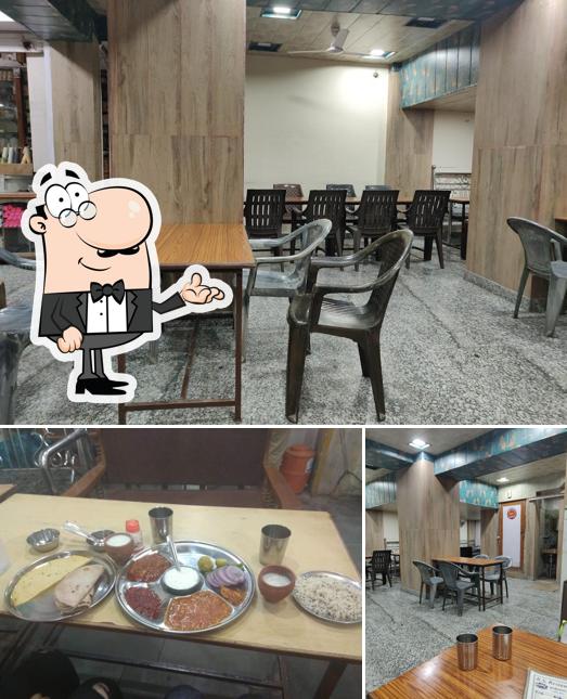 Take a seat at one of the tables at R S Restaurant and hotel