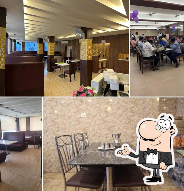 Take a seat at one of the tables at AMBUR STAR BRIYANI CHANGED TO STAR DELUXE BIRYANI OLD SHOP