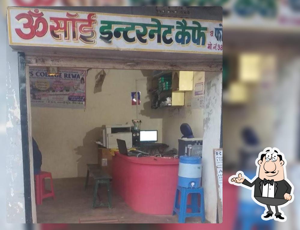 Take a seat at one of the tables at OM SAI INTERNET CAFE AND PHOTO COPY