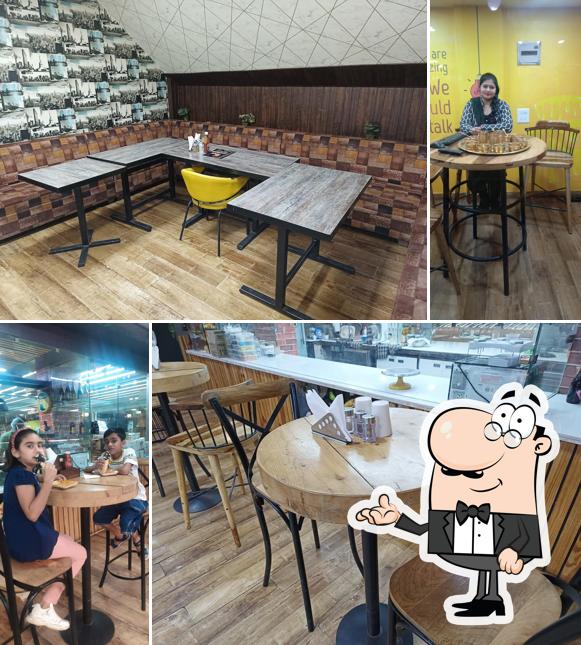 Take a seat at one of the tables at ROYAL LIVE BAKERY & RESTAURANT - BAKERY IN HISAR