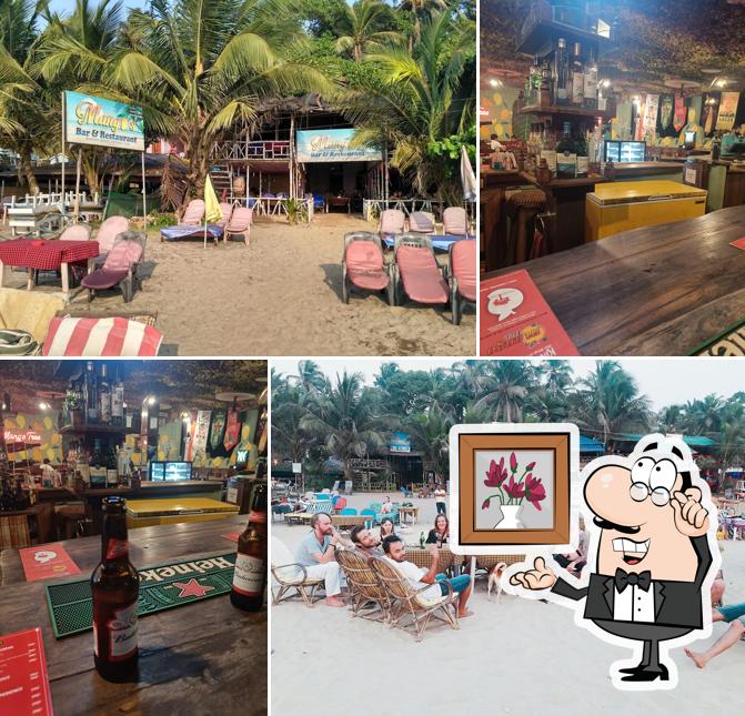 Take a seat at one of the tables at Mango Tree Bar & Restaurant