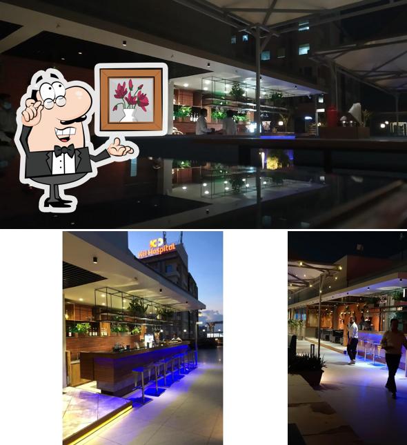 Take a seat at one of the tables at Rasa Restro Cafe & Rooftop